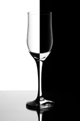 glass glasses half on white background in half on a black background