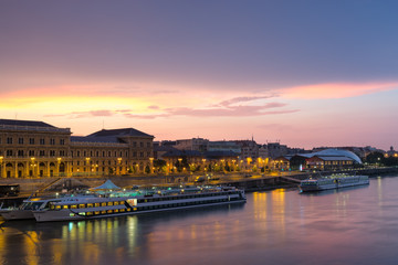 Salkaházi Sára riverfront with Corvinus university building and ships at pier, sunrise, Budapest