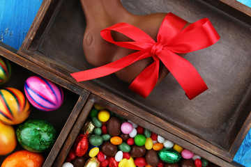 Chocolate Easter eggs and chocolate bunny and colorful sweets.