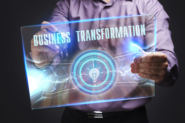 The concept of business, technology, the Internet and the network. A young entrepreneur working on a virtual screen of the future and sees the inscription: Business transformation