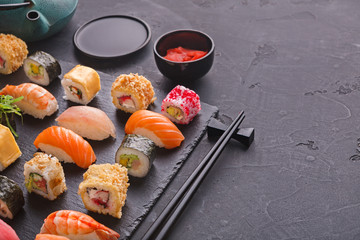 Set of sushi maki and rolls on gray background