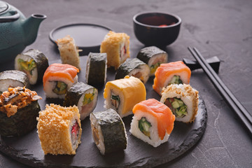 Set of sushi maki and rolls on gray background