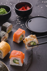 Set of sushi maki and rolls on gray background