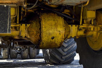 Wheel axle of the tractor. Tractor, standing in a row. Agricultural machinery. Parking of agricultural machinery