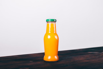 Bottle of orange juice with green cap