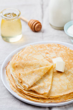 Thin crepes or pancakes with butter and sour cream