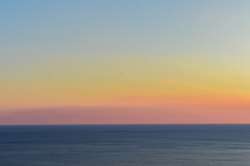 Naklejka na ściany i meble beautiful sunset over sea horizon over water 