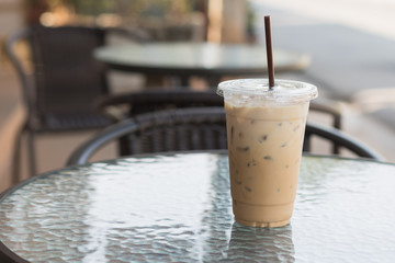 Ice Coffee in plastic take away cup.Outdoor cafe.summer cafeine drinking