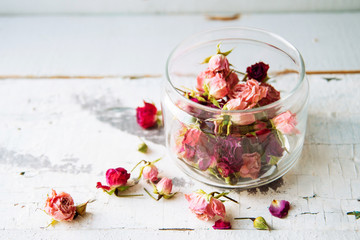 Rose buds tea, tea strainer and glass jar. Selective focus.
