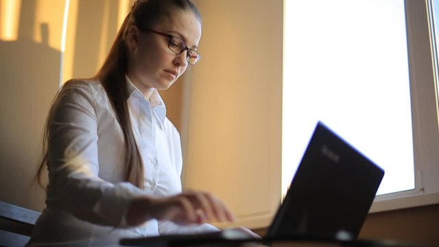 business woman works in office office computer. Compiles a financial report and scolds his employees by phone. Emotions, shouts, swears.
