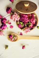 pink buds in a glass jar on a white background