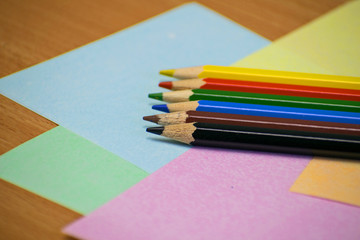 Fototapeta premium Close up stack colour pencils on papper and wooden background