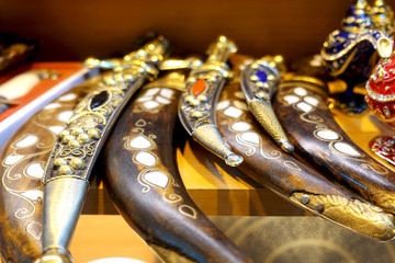 Ancient daggers in a sheath decorated with precious stones.