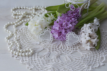 a festive background with hyacinths, hearts and pearls. March 8, mother's day, wedding, birthday.