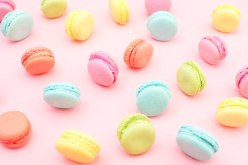 Multicolored macaroons on pink background