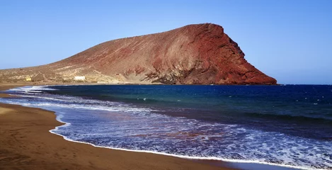 Fotobehang Beautiful coastal view of Playa de la Tejita with Montana Roja (Red Mountain).La Tejita beach in El Medano,Tenerife,Canary Islands,Spain. © svf74