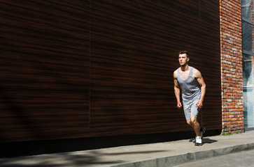 Young man running in city copy space