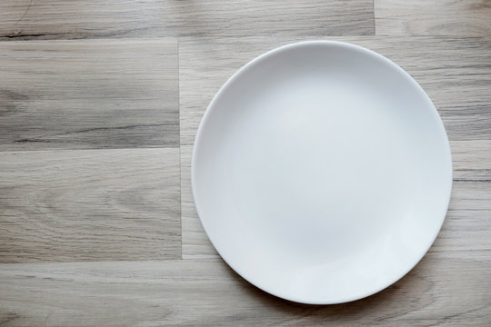 Empty plate on the wood flord.