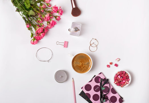 Roses, coffe and small stylush feminine accessories on the white backround
