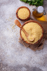 Couscous grain in wooden bowl 