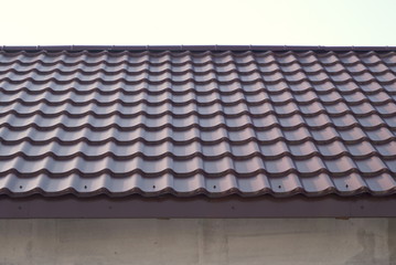 Modern roof covered with tile effect PVC coated metal roof sheets 