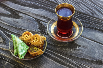 Turkish dessert. Oriental sweets with nuts and honey on a wooden background.