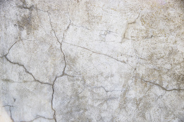 Concrete wall with cracks. Gray urban background. Space for text