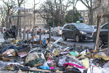 Garbage in the street, Paris, France, winter 2018, half burnt garbage left over the pavement in the...