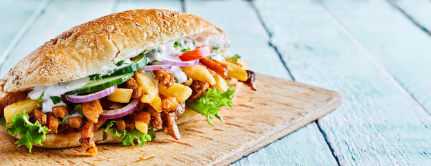Greek gyros burger with roasted sliced meat