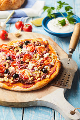 Whole Greek pizza with olives and feta cheese