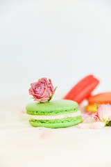 Obraz na płótnie Canvas Dessert: A Delicate Fresh Colorful French Macaroons In Pastel Colors Gift Box Flowers Roses On Light Textiles Background