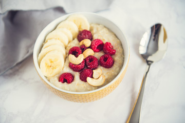 healthy oatmeal Breakfast with banana and raspberry