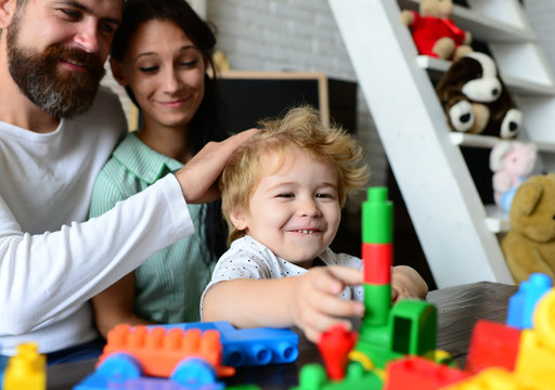 Young family spends time in playroom. Mom, dad and boy