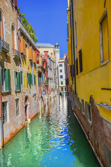 Fototapeta na wymiar Gondola Tourists Colorful Small Side Canal Venice Italy