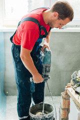 Worker mixing plaster