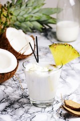 Coconut alcohol cocktail on the light background. Coconut pina colada isolated