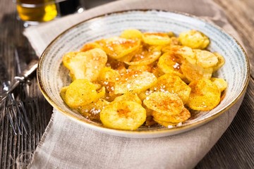 Roasted potatoes on wooden background