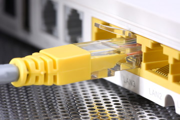 Network cable and router closeup with selective focus