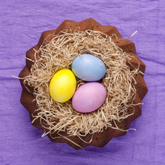 Easter still life, Easter cake, on a violet textile background.