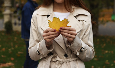 the leaf is in the girl's hand