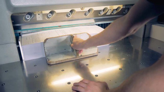 Timelapse. Paper cutting machine cut paper for pieces.