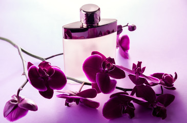 Bottle of perfume with orchid