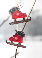 Vintage decorative red skates on a winter background. Selective focus. Christmas mood.