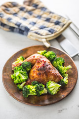 Roast chicken Leg. Chicken roasted leg with broccoli on table