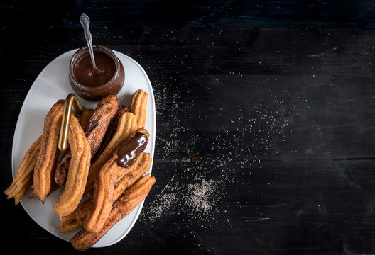 Traditional Mexican dessert churros with chocolate served,selective focus and blank space