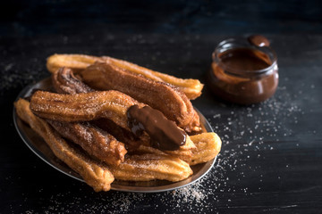 Close up to traditional Mexican dessert churros with chocolate,selective focus