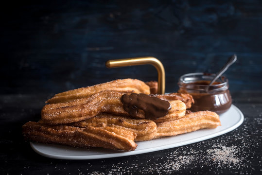 Traditional Mexican dessert churros with chocolate cream served,selective focus