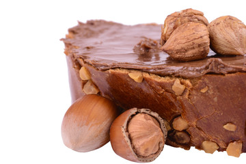 hazelnuts and bun with chocolate cream isolated on white background