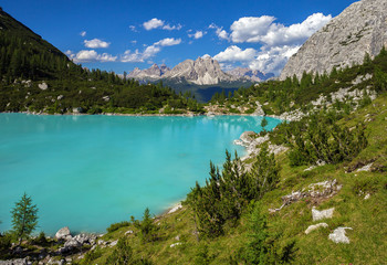 Naklejka na ściany i meble Amazing view of Sorapis lake with unusual color of water. Lake located in Dolomite Alps, Italy