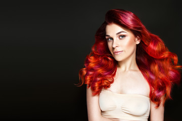 Beautiful woman portrait with gorgeous red wavy hair.